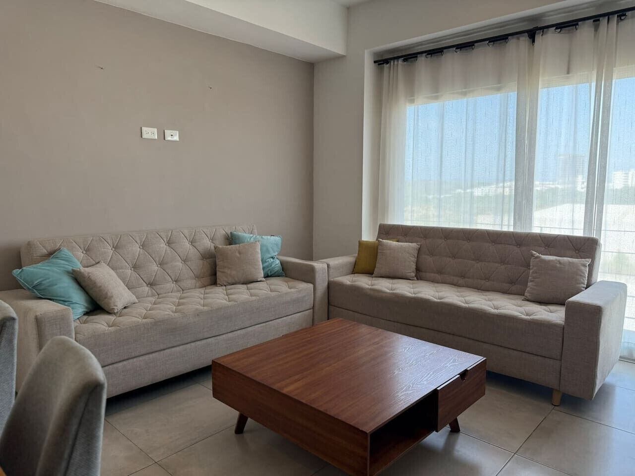 A living room with two sofas and a wooden coffee table.