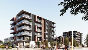 A multi-story residential building with balconies, a pedestrian crossing, and a street with people and vehicles. - Stadium & Port Hills View 1BR Apartment | Balcony (Christchurch)