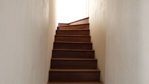 A wooden staircase in a narrow hallway with plain walls. - House for 8 near beach, pets allowed (La Tranche-sur-Mer)