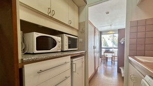 A compact kitchen with white cabinets, a microwave, and a small refrigerator. - Studio for 4 near slopes with free wifi and parking (Le Dévoluy)