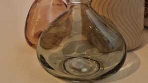 Two glass bottles and a textured vase on a table. - Cozy 1-room apartment in the Hildesheim forest (Diekholzen)