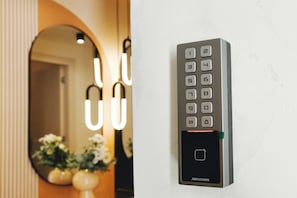 A wall-mounted electronic keypad with a numeric keypad and a small display, likely for room access or control. - Rosa Marina rooms - Comfort room (Cagliari)