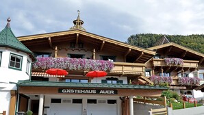 A traditional Alpine building with a sign reading "Gastehaus Auer". - in ruhiger Lage nahe am See by Interhome (Thiersee)