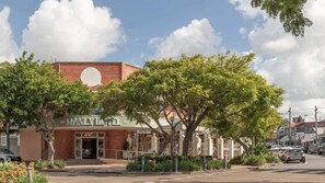 A hotel with a brick facade, a large circular window, and a sign reading 'The Manly Hotel.' - 4BDR Queenslander with Pool Near Manly Esplanade (Manly)