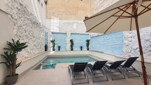 An indoor swimming pool with tiled flooring, lounge chairs, and potted plants. - Ap. Marino 2nd floor shared heated swimming pool (Alicante/Alacant)
