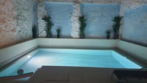 A small indoor pool with a tiled floor and walls, surrounded by potted plants. - Ap.Marino 3rd floor shared heated swimming pool (Alicante/Alacant)
