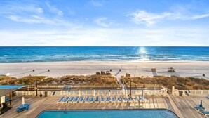 A beachside hotel with a pool, sun loungers, and a view of the ocean. - Brand New Luxury | Sunset Balcony | 3 Pools (panama city beach)