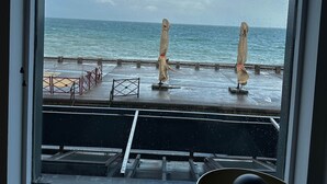 A view from a window overlooking a pier with a railing, a metal structure, and a lamp on the windowsill. - Captain YOO - The panorama / horizon, fabulous sea view (Fécamp)