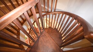 Una scala a chiocciola in legno con ringhiera e gradini.