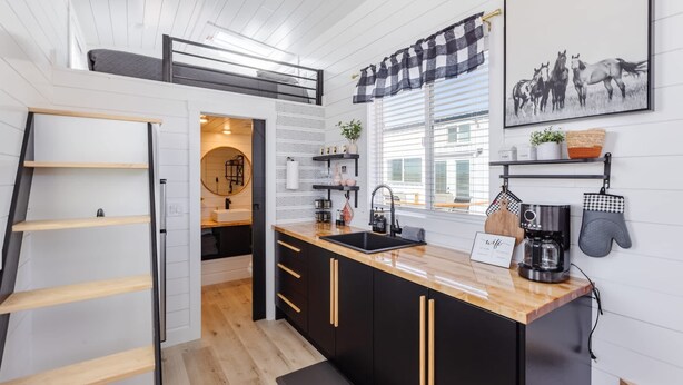 A compact kitchen with black cabinets, a wooden countertop, and a black coffee machine. - Zion Tiny Home • Hot Tub •  Gooseberry Mesa Trails (Apple Valley)