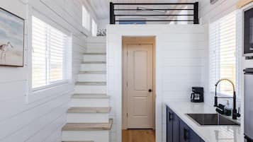 Fridge, microwave, coffee/tea maker, cookware/dishes/utensils