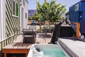A deck with outdoor seating, a hot tub, and a barbecue grill. - Zion Basecamp • Hot Tub • Mountain Biking & Hiking (Apple Valley)