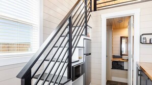 A modern kitchen with a built-in oven, a microwave, and a wooden countertop. - Zion Adventure • Private Hot Tub + Starry Nights (Apple Valley)
