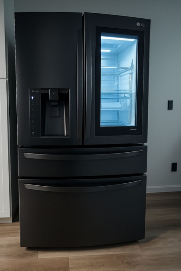 A black LG refrigerator with a water dispenser and a freezer compartment.