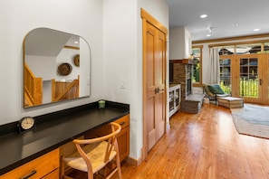 A modern kitchen with a wooden countertop, a mirror, and a clock. - Modern Big Sky Retreat  | Hot tub + Shared Pool (Big Sky)