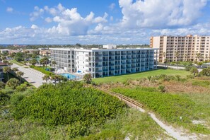 Exterior - Sunny Cape Canaveral Retreat: Balcony Views, Heated Pool, Spa‑Like Hot Tub & Steps to Beach ☀️ (Cape Canaveral)