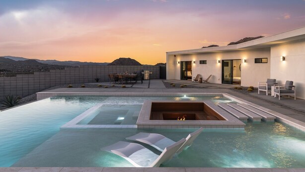A modern outdoor pool area with a hot tub, lounge chairs, and a dining setup. - Celestine - Modern w Pool Near Park Entrance (Joshua Tree)