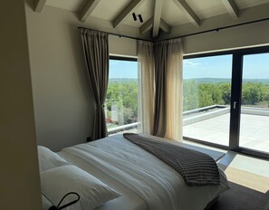 A bedroom with a large bed, two windows with curtains, a view of greenery, and a balcony. - Villa Lavis (Istria - Sveti Lovreč) (Sveti Lovreč)