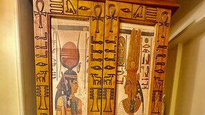 A wardrobe with Egyptian hieroglyphs and figures. - The Helio Suite Modern 1 bdrm (Heliopolis)