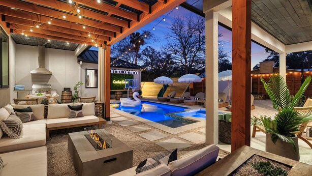 An outdoor living area with a pool, lounge chairs, and a fire pit. - Cactus Cove - Luxe Adventures by Hello Hideout (Austin)