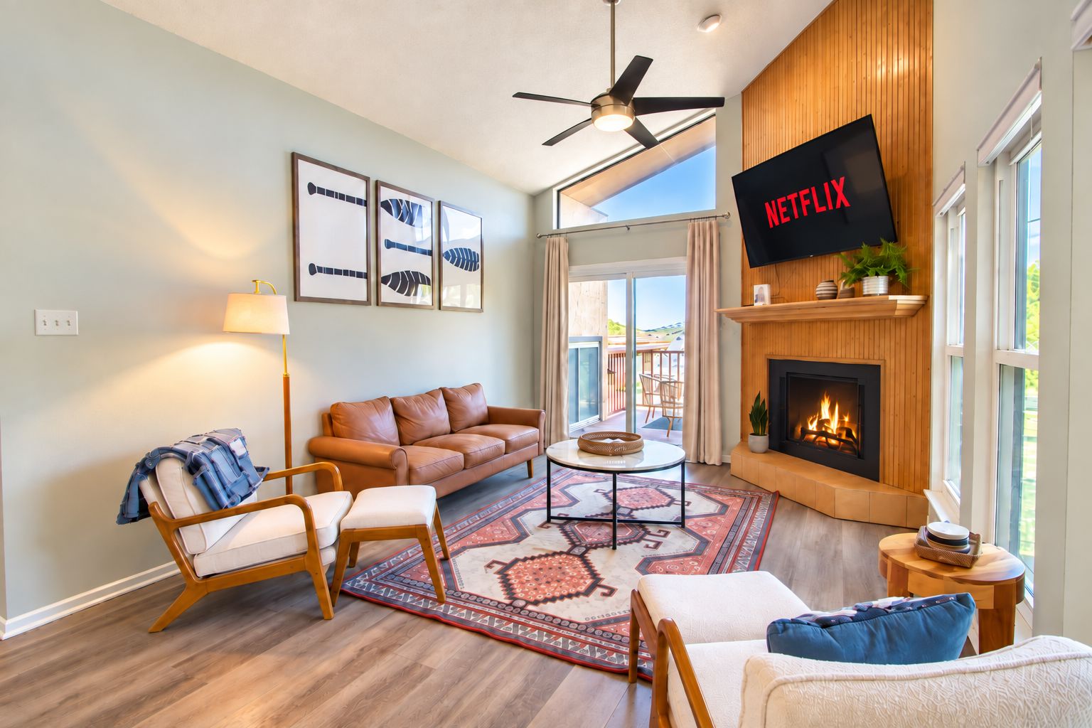 A modern living room with a leather sofa, a coffee table, and a fireplace.