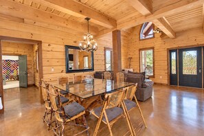 A spacious wooden interior with a large dining table, comfortable seating, and a large mirror. - Luxe Lake Living with Bonus Bunk Area & Private Boat Parking - Dogs Welcome (Canyon Lake)