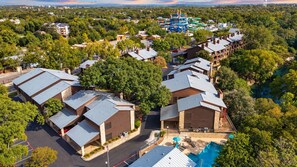 A residential area with multiple houses, a swimming pool, and a water park. - 2BR Condo W/ Pool, Hot Tub, Grills, Walk to Schlitterbahn! (New Braunfels)