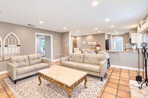A spacious living room with a beige sofa set, a marble coffee table, and a patterned rug. - Dog-friendly chic home w/private outdoor pool, gas grill, & enclosed backyard (San Antonio)
