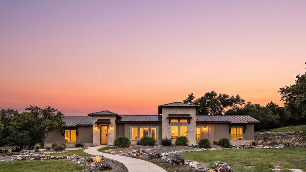 A modern two-story house with a stone facade, large windows, and a curved driveway. - The All-Suite Century Oak House - Steps to Remi's Ridge & Hayes Hollow (Spring Branch)