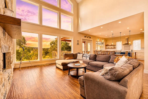 A spacious living room with a fireplace, large windows, and a view of the outdoors. - Lakeside Serenity with Private Waterfront Access on Canyon Lake (Canyon Lake)