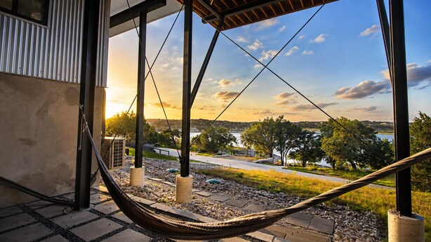 A hammock under a pergola with a view of a lake and trees. - Modern lakefront home with multi levels and gorgeous views and Winter Texan Friendly (Canyon Lake)