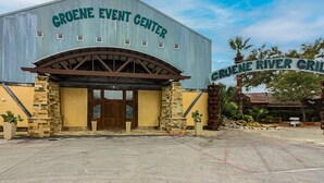 The Gruene Event Center building with a large sign reading "Gruene River Grill" in front. - Gruene Envy – a first floor Poolside Condo with Guadalupe River Access (New Braunfels)