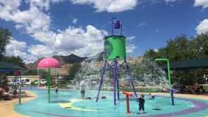 A water play area with multiple water jets and a central water tower. - Remodeled home across from river, train and park! (Cañon City)