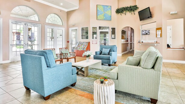 A spacious lobby with multiple seating areas, a coffee table, and a map on the wall. - Dog-friendly home with private outdoor pool, high-speed WiFi, and central AC (Davenport)
