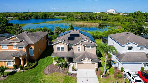 A residential area with houses, a lake, and a clear sky. - Stunning house with lanai, pool, ping-pong, full kitchen, & WiFi (Davenport)