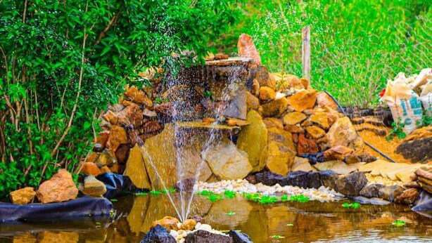 A waterfall feature surrounded by rocks and greenery.