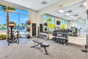 A gym with exercise equipment, a bench, and a rack of dumbbells. - Spacious private home w/ private pool, resort style waterpark & mini golf access (Davenport)