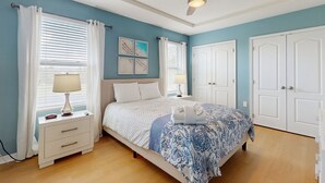 A bedroom with a bed, nightstands, a ceiling fan, and a window with curtains. - Townhome with private pool in Solterra resort, ADA friendly (Davenport)