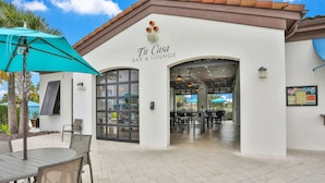A bar and lounge named "Tu Casa" with outdoor seating and a tiled patio. - Fun, dog-friendly home with private pool, high-speed WiFi, W/D, & game rooms (Kissimmee)