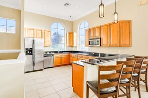 Fridge, microwave, oven, stovetop - Vibrant modern home with private pool, spa, lanai & expansive game room (Haines City)