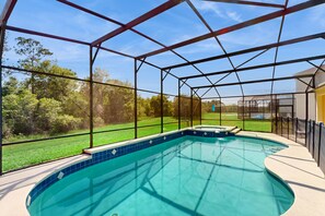 A heated pool - Sprawling home with pool, pool spa, & game room - athletic court and gym access (Kissimmee)