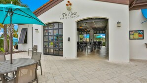 A bar and lounge named 'Tu Casa' with outdoor seating and a tiled patio. - Updated & colorful home w/ a modern kitchen, furnished lanai, & private pool (Kissimmee)