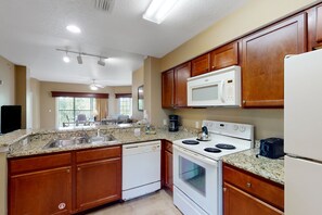 Fridge, microwave, oven, stovetop - Inviting 4th-floor condo with elevator, screened balcony, washer/dryer & AC (Orlando)