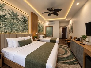 A hotel room with a large bed, a desk, a chair, a ceiling fan, and a wall-mounted TV. - Dawn Boutique Luangprabang Hotel (Luang Prabang)