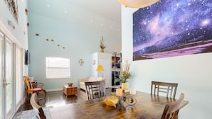 A dining area with a wooden table, chairs, and a candle holder. - Riverfront home with internet, washer and dryer, and perfect for kayaking (Sebring)