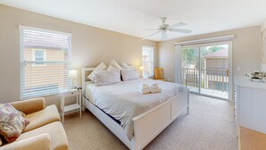 A bedroom with a bed, a desk, a chair, and a balcony. - Sunny Oasis | Townhouse in Davenport with resort amenities, near Disney (Davenport)
