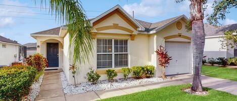 A single-story house with a front garage, a covered porch, and a well-maintained lawn.