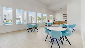 A spacious room with large windows, a kitchen area, and multiple seating arrangements. - Modern Townhouse with Private Pool Near Disney & Top Attractions (Davenport)
