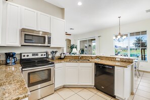 Fridge, microwave, oven, stovetop - Waterview Home w/ Private Pool, High-Speed WiFi, and Central AC (Kissimmee)