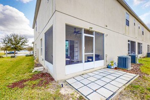 Un bâtiment doté de grandes fenêtres, d’un patio couvert et de climatiseurs extérieurs.